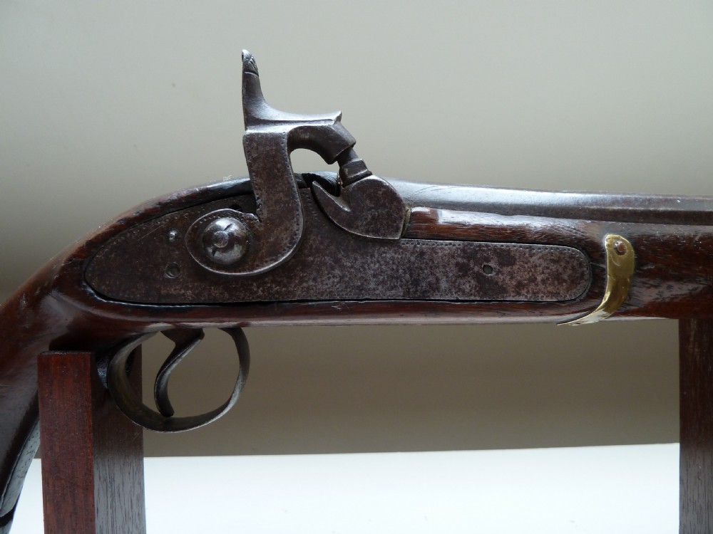 A 19th-century single-barrel percussion cap pistol featuring a dark wood stock, steel lock mechanism, and brass mountings. View II
