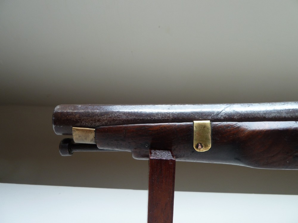 A 19th-century single-barrel percussion cap pistol featuring a dark wood stock, steel lock mechanism, and brass mountings. View VI