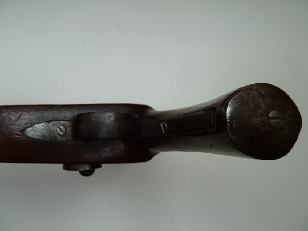 A 19th-century single-barrel percussion cap pistol featuring a dark wood stock, steel lock mechanism, and brass mountings. View X