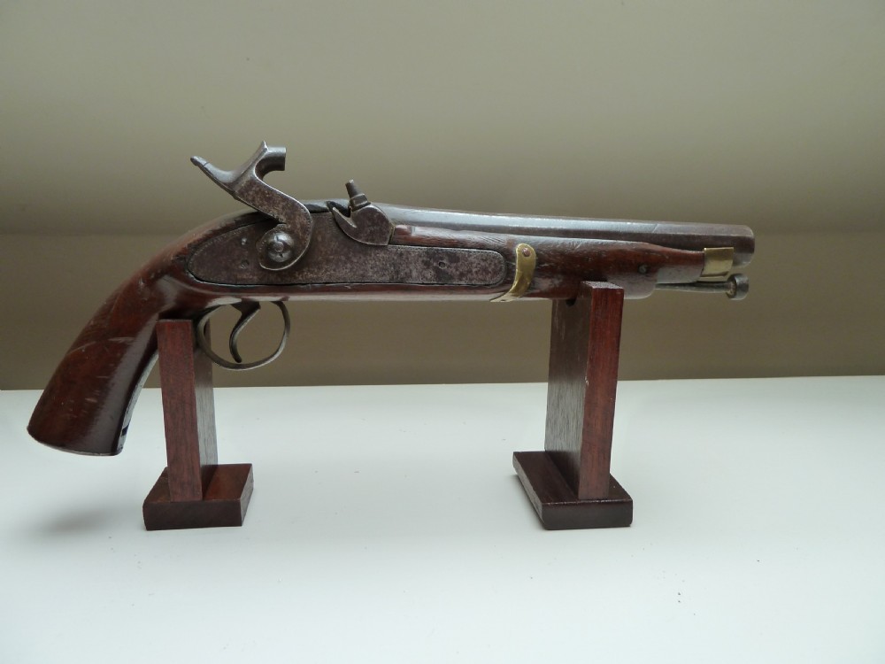 A 19th-century single-barrel percussion cap pistol featuring a dark wood stock, steel lock mechanism, and brass mountings. View XII