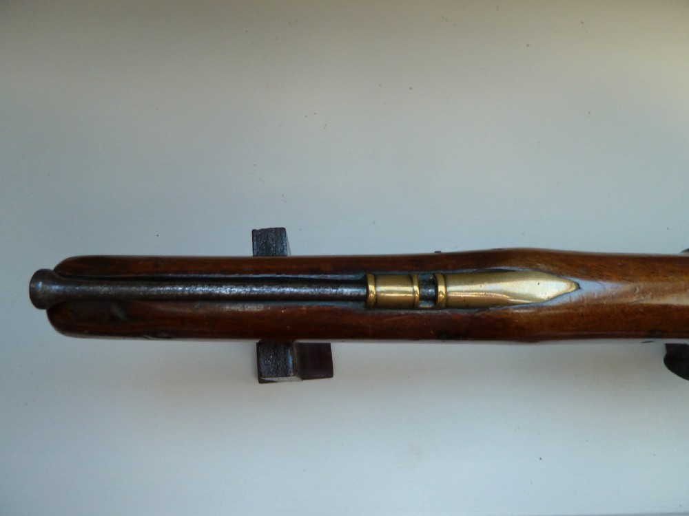 An antique British long-barrelled flintlock dragoon pistol featuring a polished walnut stock, steel barrel, steel lock mechanism, and brass fittings. View VIII