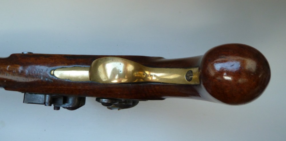 An antique British long-barrelled flintlock dragoon pistol featuring a polished walnut stock, steel barrel, steel lock mechanism, and brass fittings. View IX