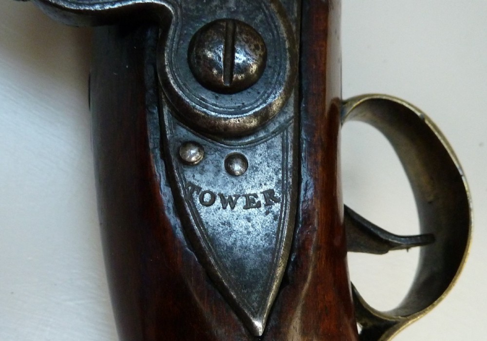 An antique British long-barrelled flintlock dragoon pistol featuring a polished walnut stock, steel barrel, steel lock mechanism, and brass fittings. View XI