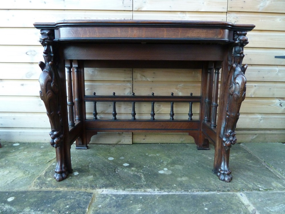 VICTORIAN OAK WRITING TABLE WITH GRIFFIN MOUNTS