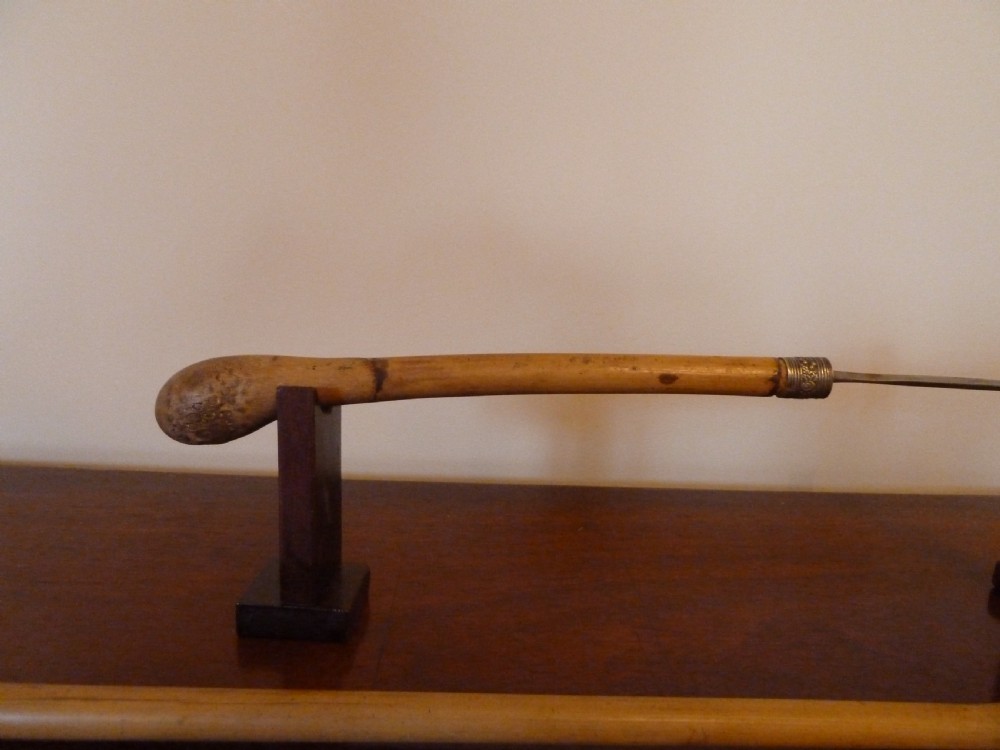 An antique bamboo swordstick shown partially unsheathed to reveal a concealed steel blade, featuring a natural bamboo handle and metal collar band. View VIII
