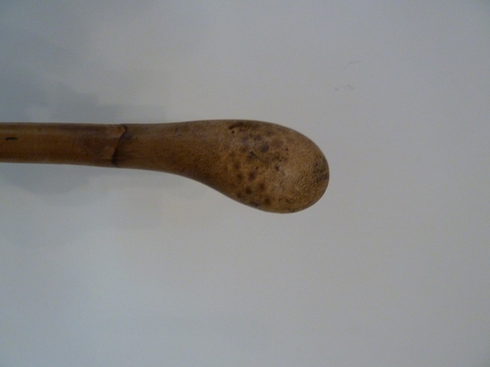 An antique bamboo swordstick shown partially unsheathed to reveal a concealed steel blade, featuring a natural bamboo handle and metal collar band. View XI