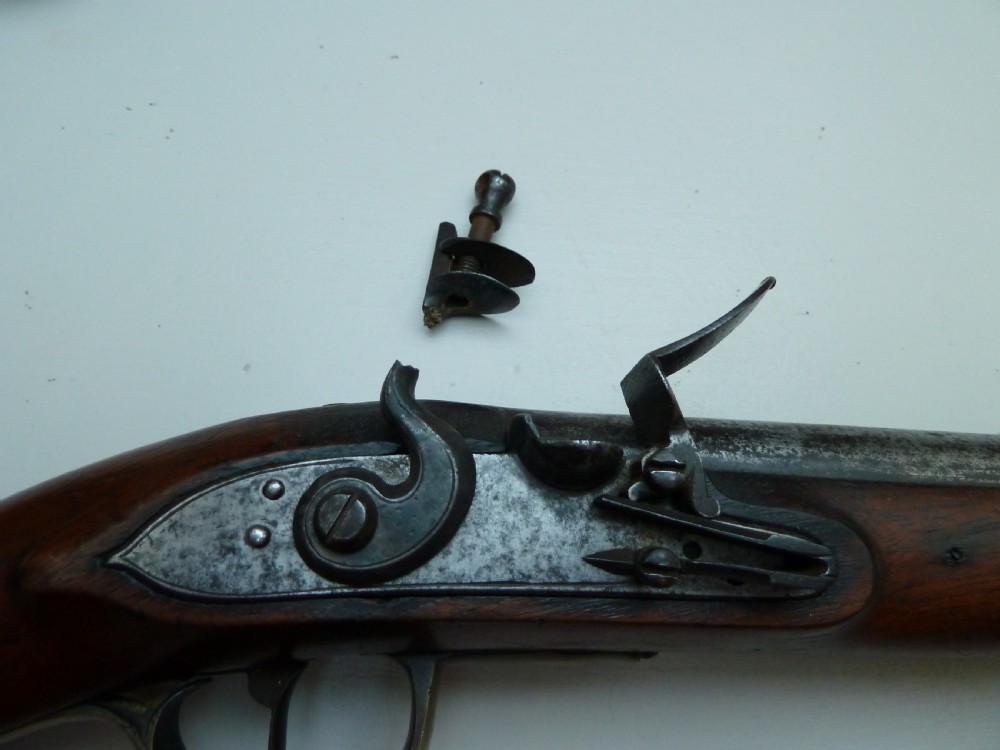 A pair of early 19th-century flintlock duelling pistols featuring contoured wooden stocks, brass sideplates, and steel barrels. View IV