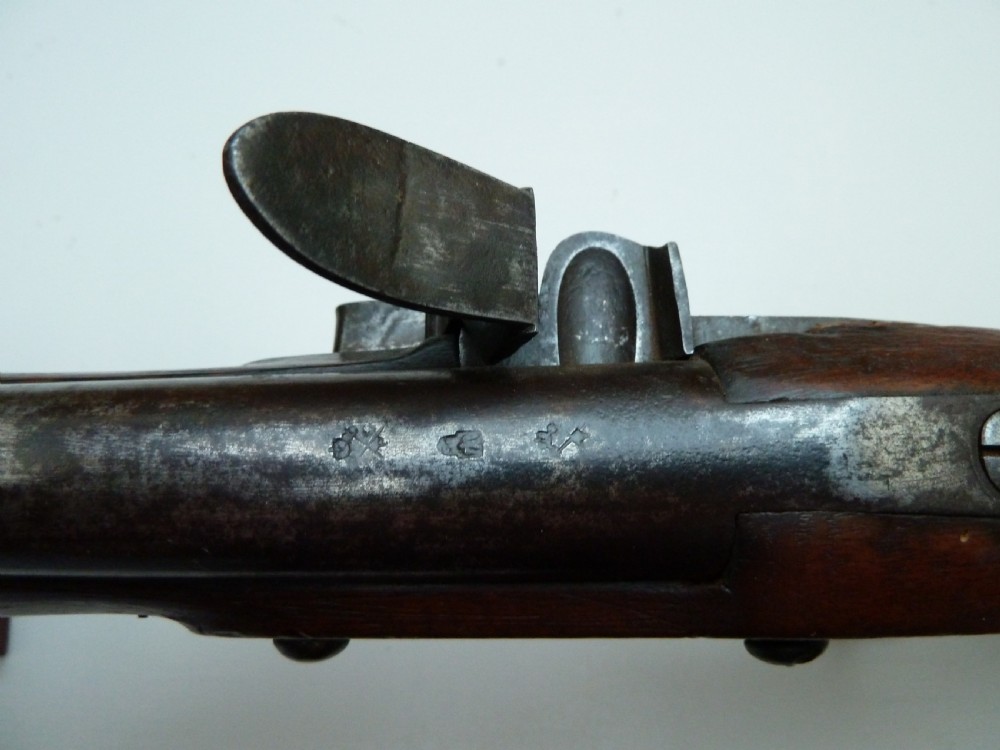 A pair of early 19th-century flintlock duelling pistols featuring contoured wooden stocks, brass sideplates, and steel barrels. View VI