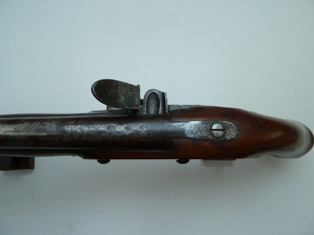 A pair of early 19th-century flintlock duelling pistols featuring contoured wooden stocks, brass sideplates, and steel barrels. View VII