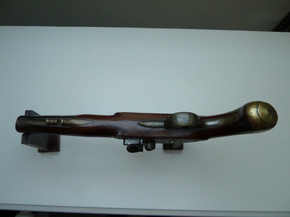 A pair of early 19th-century flintlock duelling pistols featuring contoured wooden stocks, brass sideplates, and steel barrels. View VIII