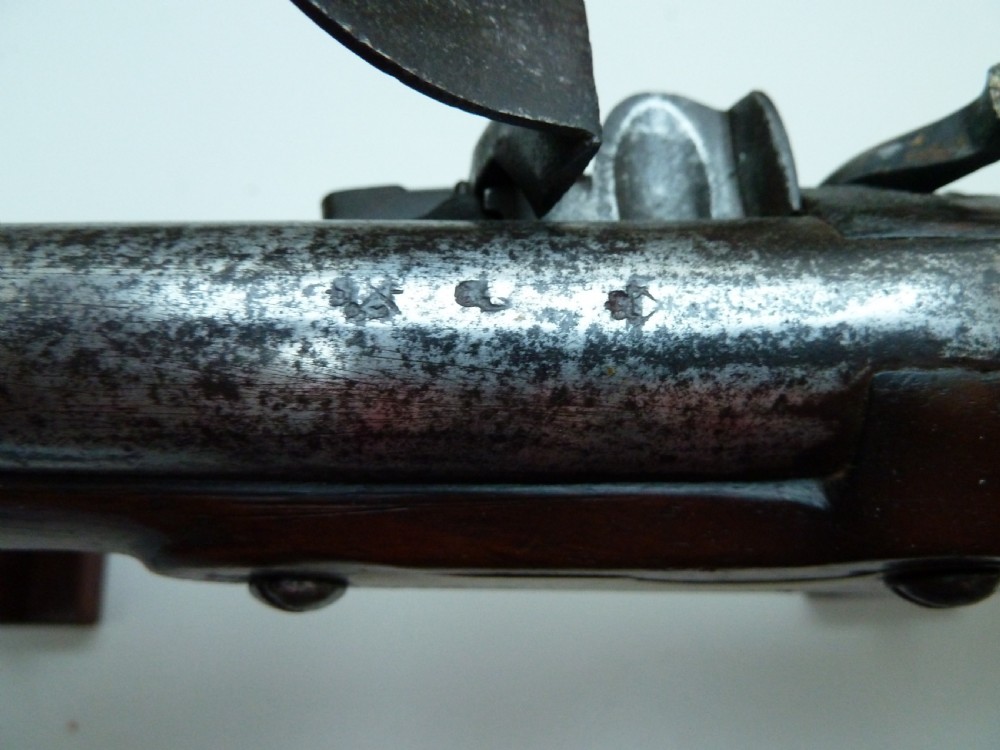 A pair of early 19th-century flintlock duelling pistols featuring contoured wooden stocks, brass sideplates, and steel barrels. View XI