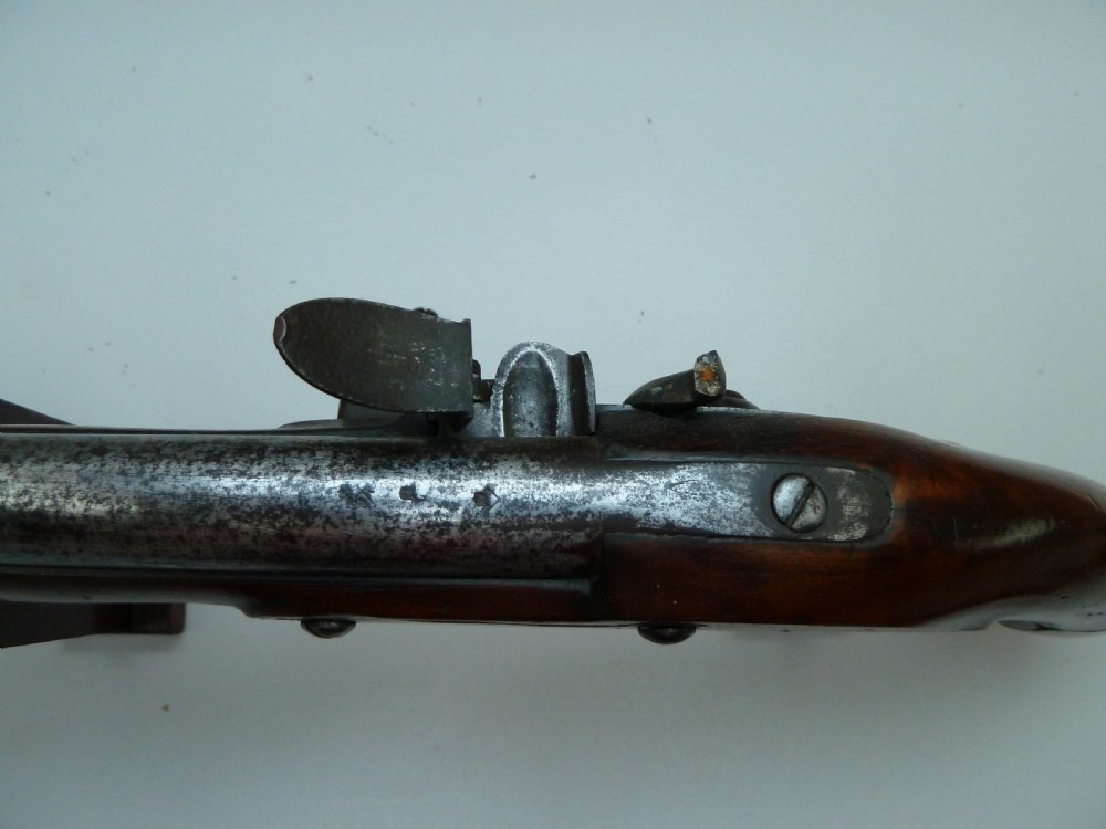 A pair of early 19th-century flintlock duelling pistols featuring contoured wooden stocks, brass sideplates, and steel barrels. View XII