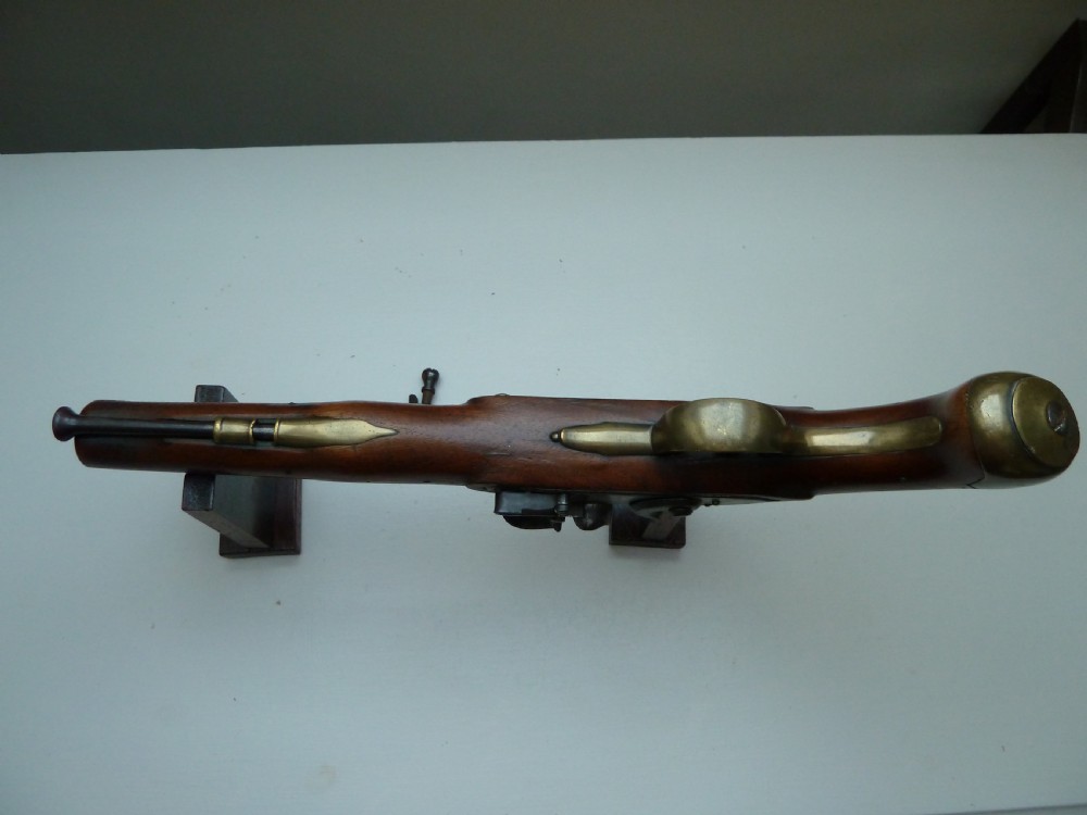 A pair of early 19th-century flintlock duelling pistols featuring contoured wooden stocks, brass sideplates, and steel barrels. View XIII