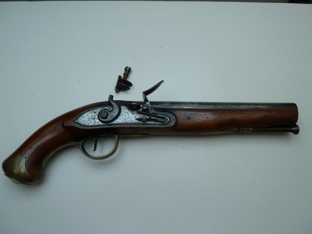 A pair of early 19th-century flintlock duelling pistols featuring contoured wooden stocks, brass sideplates, and steel barrels. View XVI