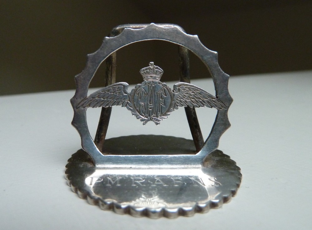 Set of four silver RAF menu holders featuring Royal Air Force wings and crown motifs on scalloped circular bases. View IV