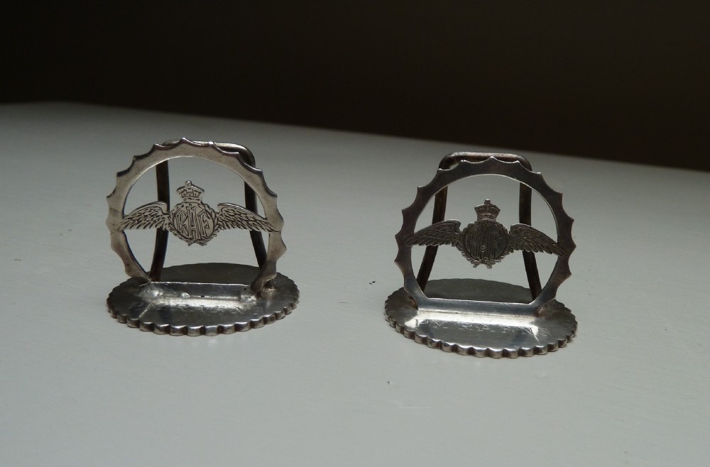 Set of four silver RAF menu holders featuring Royal Air Force wings and crown motifs on scalloped circular bases. View VI