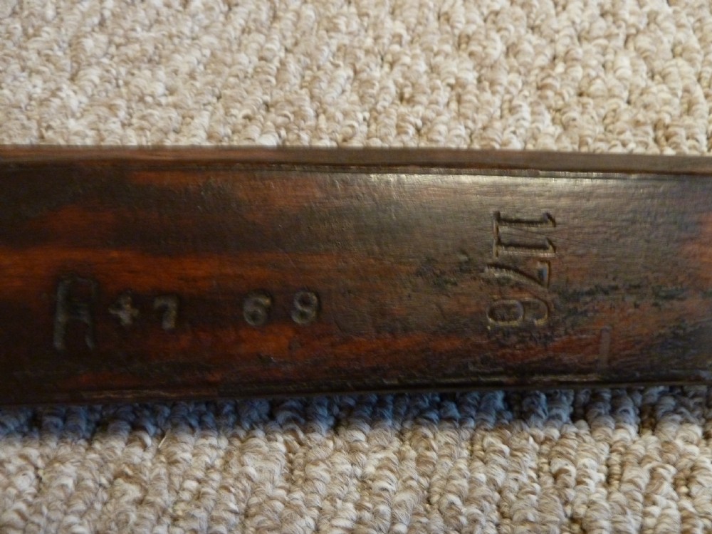 An antique Indian matchlock Torador musket featuring a long steel barrel bound with brass straps to a dark wood stock. View VII