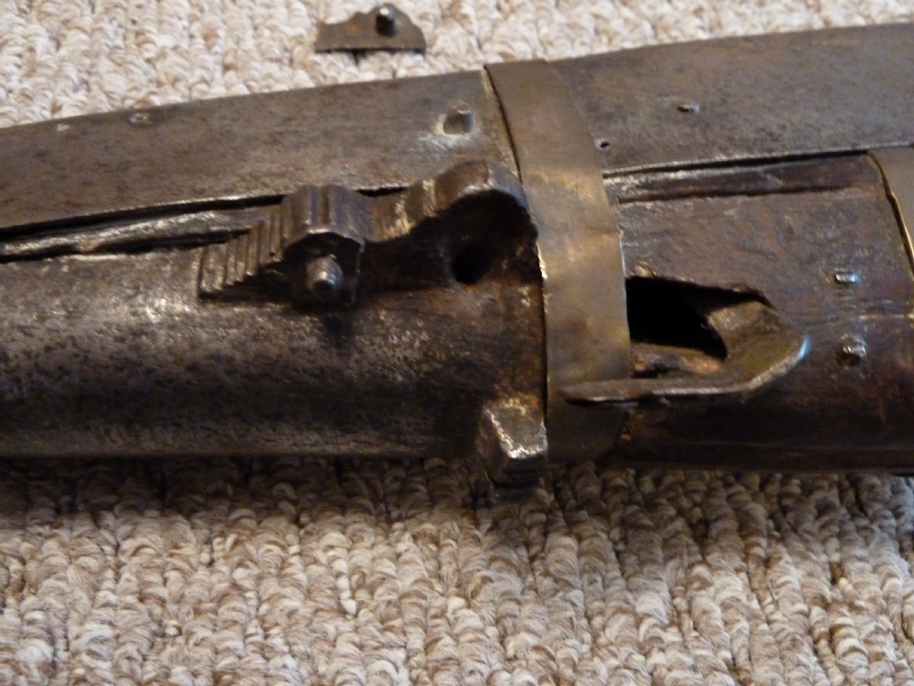 An antique Indian matchlock Torador musket featuring a long steel barrel bound with brass straps to a dark wood stock. View VIII