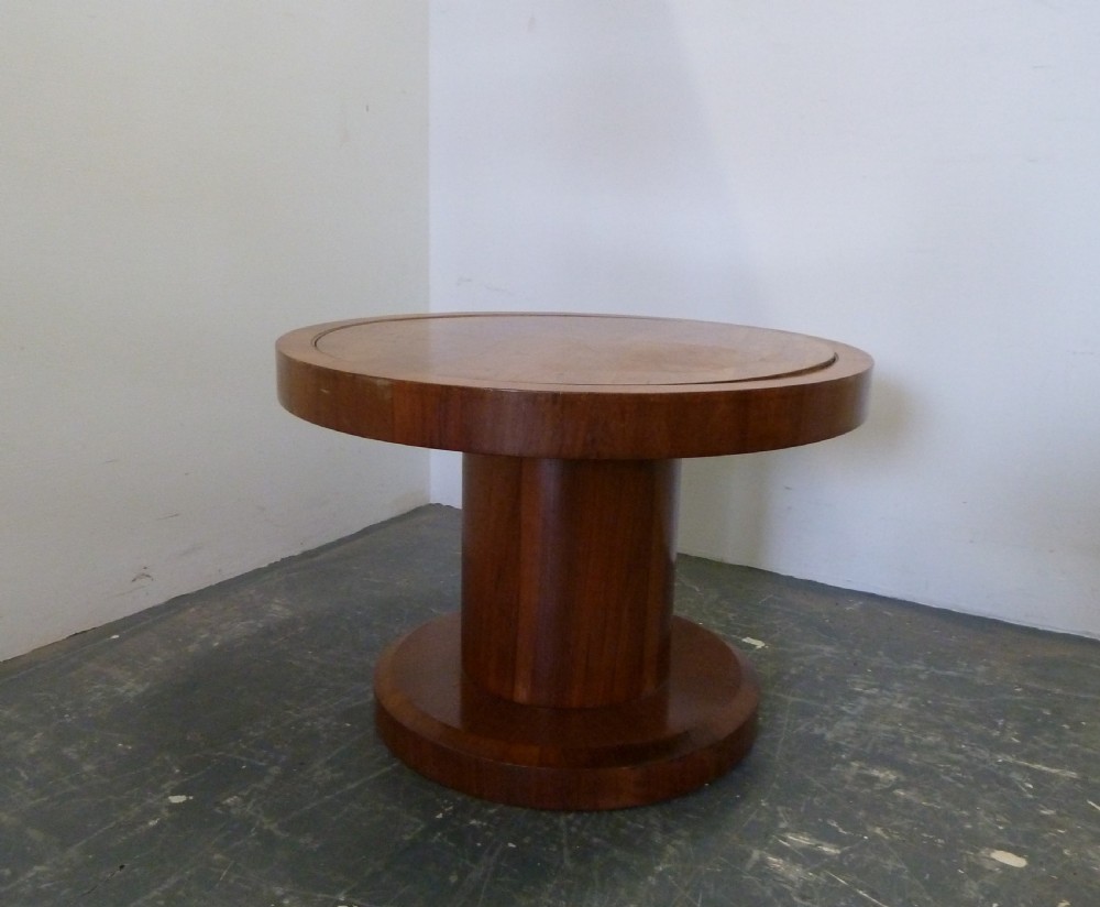 A circular Art Deco walnut metamorphic card table featuring a quarter-veneered top, central cylindrical column, and tiered circular shelf. View II