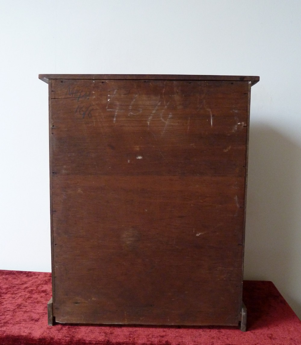 A Victorian pine chest featuring six shallow drawers with turned wooden knobs and a solid plinth base. View IV
