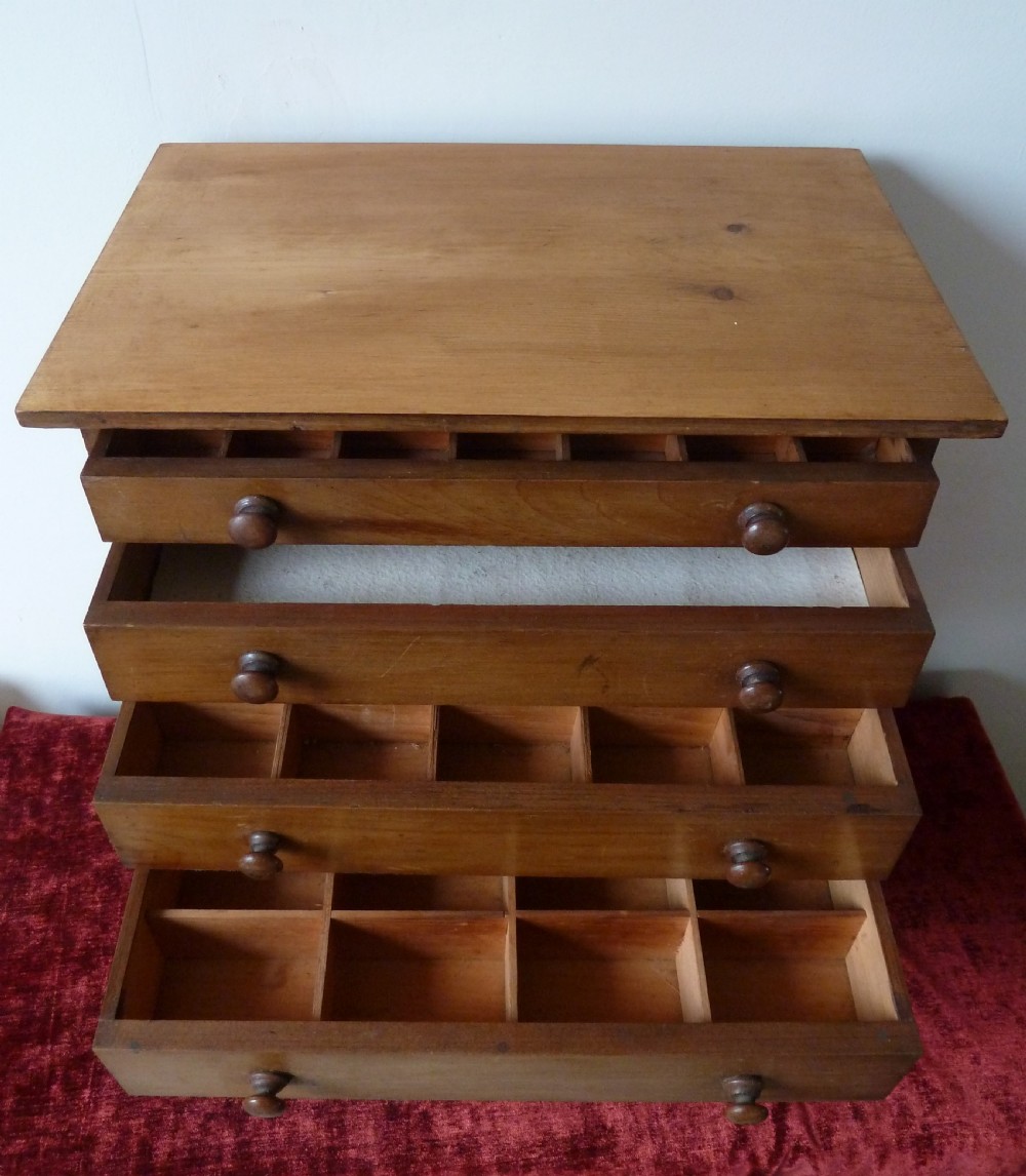 A Victorian pine chest featuring six shallow drawers with turned wooden knobs and a solid plinth base. View IX
