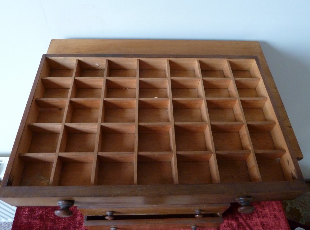 A Victorian pine chest featuring six shallow drawers with turned wooden knobs and a solid plinth base. View X