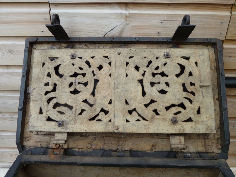 A heavy 17th-century black wrought iron Armada chest with external iron strapwork, side drop handles, and a key sticking out from the top lid. View VII