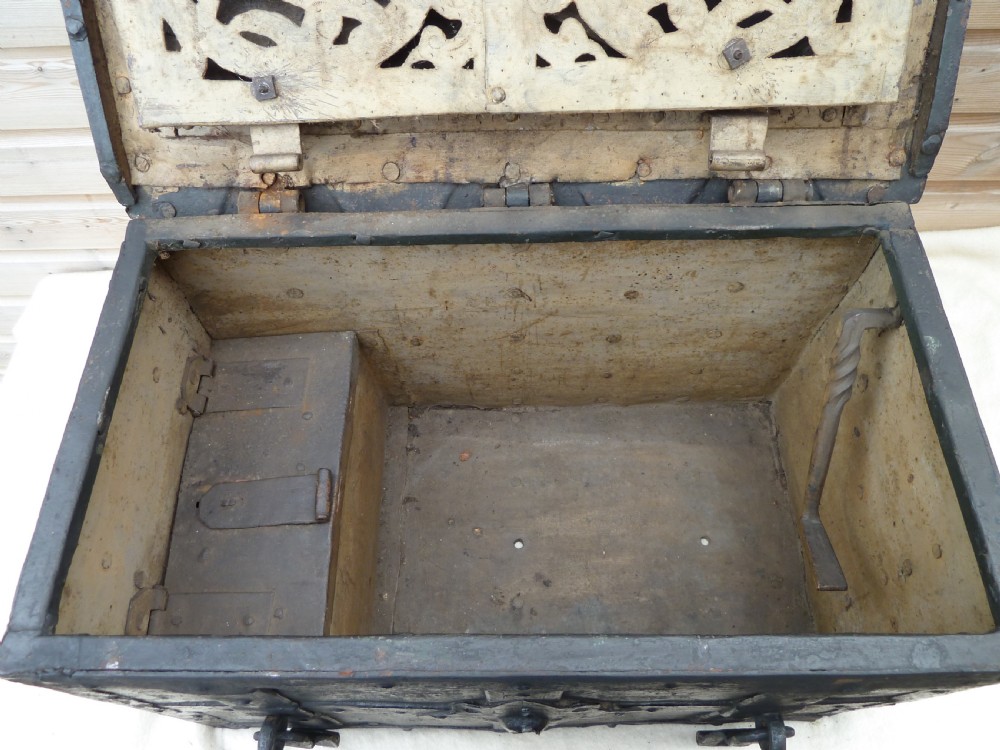 A heavy 17th-century black wrought iron Armada chest with external iron strapwork, side drop handles, and a key sticking out from the top lid. View VIII