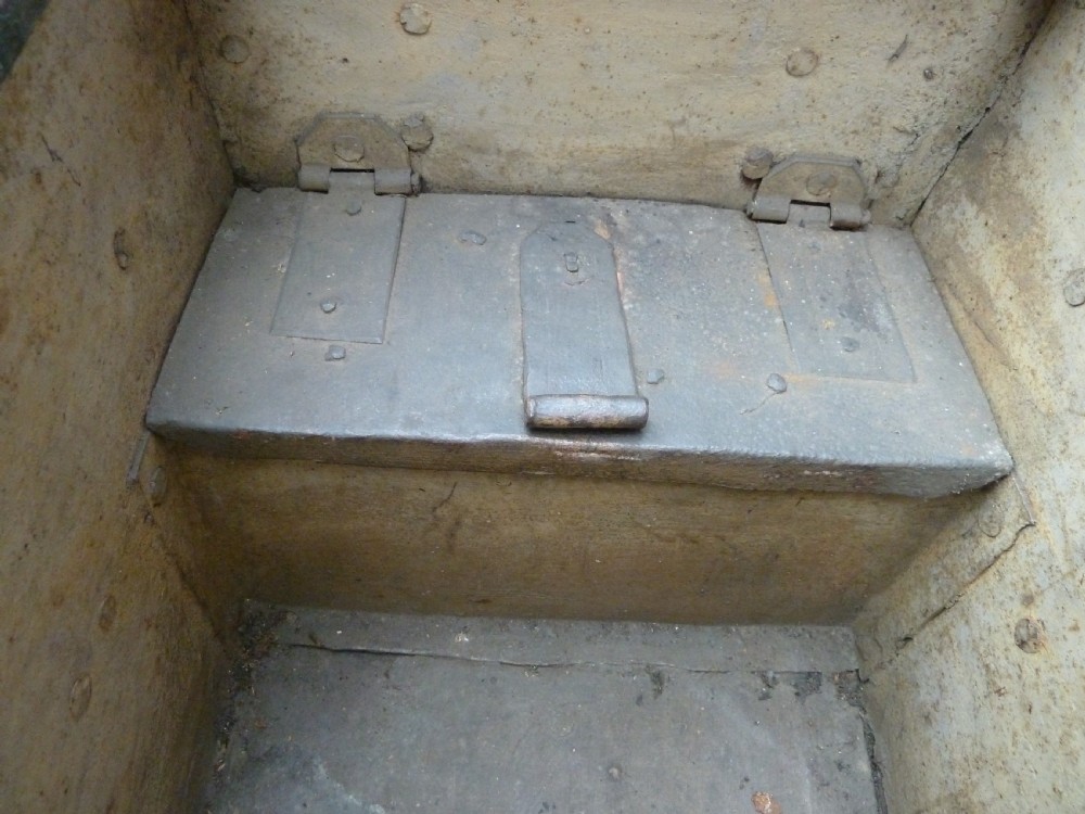 A heavy 17th-century black wrought iron Armada chest with external iron strapwork, side drop handles, and a key sticking out from the top lid. View IX