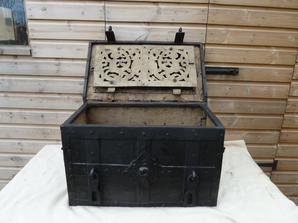 A heavy 17th-century black wrought iron Armada chest with external iron strapwork, side drop handles, and a key sticking out from the top lid. View XI