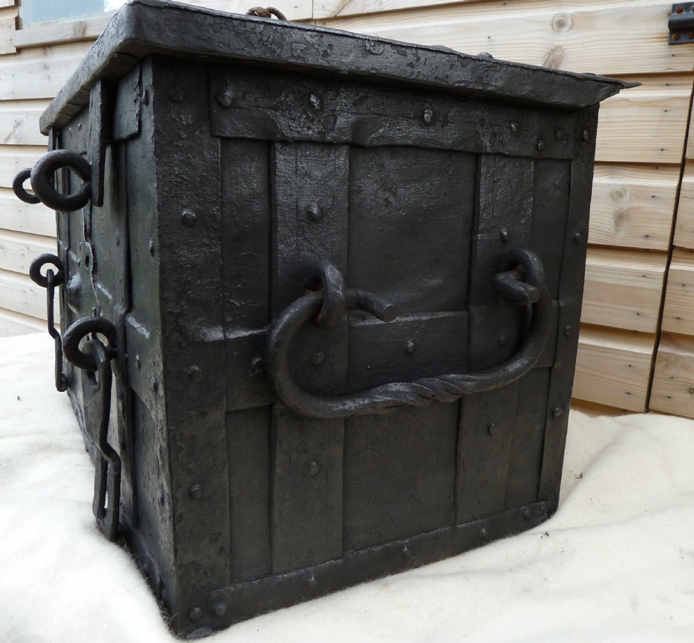 A heavy 17th-century black wrought iron Armada chest with external iron strapwork, side drop handles, and a key sticking out from the top lid. View XIII