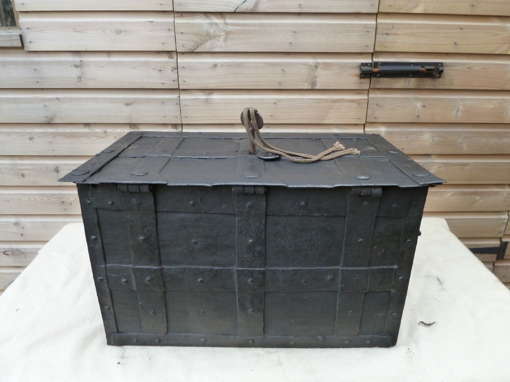 A heavy 17th-century black wrought iron Armada chest with external iron strapwork, side drop handles, and a key sticking out from the top lid. View XV