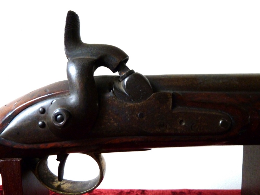 An antique 19th-century East India Company percussion pistol with a dark walnut stock, steel barrel and lock, brass trigger guard, and captive swivel ramrod. View II