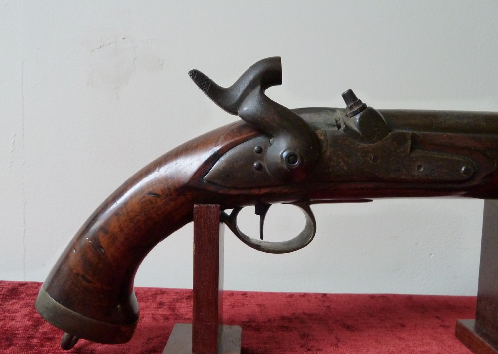 An antique 19th-century East India Company percussion pistol with a dark walnut stock, steel barrel and lock, brass trigger guard, and captive swivel ramrod. View III