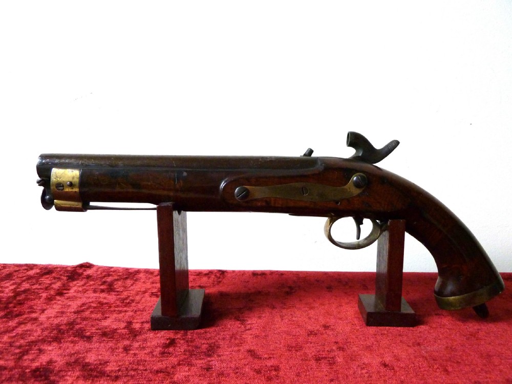An antique 19th-century East India Company percussion pistol with a dark walnut stock, steel barrel and lock, brass trigger guard, and captive swivel ramrod. View IV