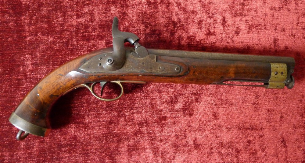 An antique 19th-century East India Company percussion pistol with a dark walnut stock, steel barrel and lock, brass trigger guard, and captive swivel ramrod. View V