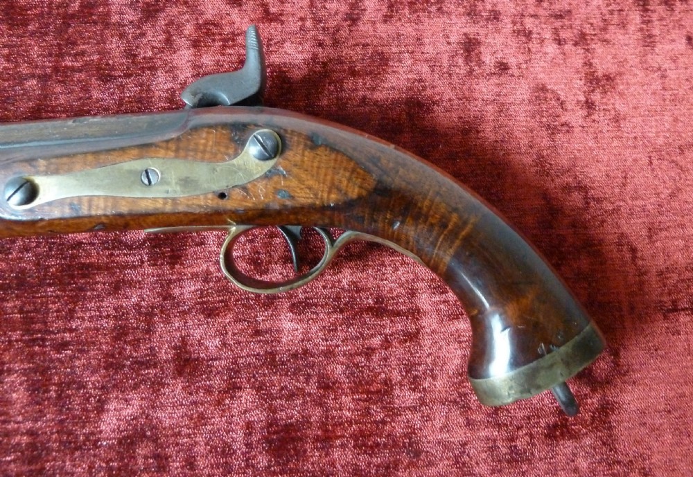 An antique 19th-century East India Company percussion pistol with a dark walnut stock, steel barrel and lock, brass trigger guard, and captive swivel ramrod. View XIII