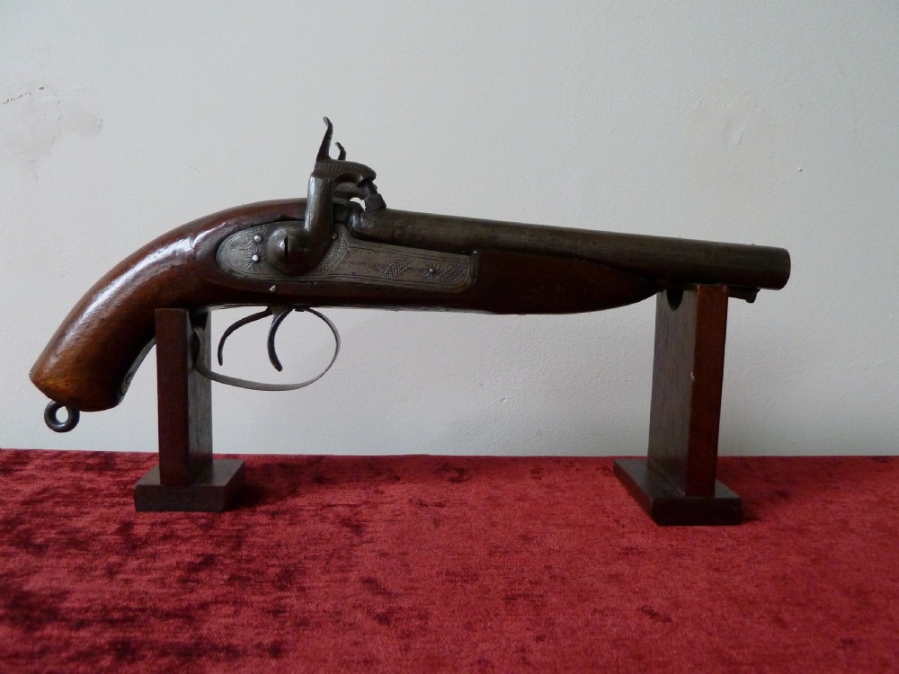 A 19th-century double-barrel percussion pistol featuring side-by-side steel barrels, dual hammers, engraved lockplates, and a smooth walnut stock. View II