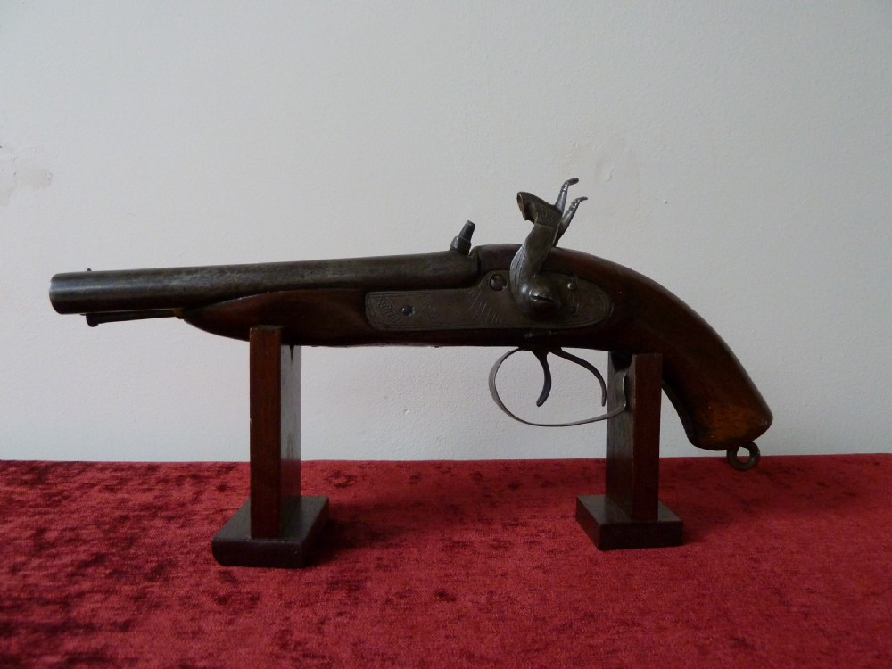 A 19th-century double-barrel percussion pistol featuring side-by-side steel barrels, dual hammers, engraved lockplates, and a smooth walnut stock. View IV