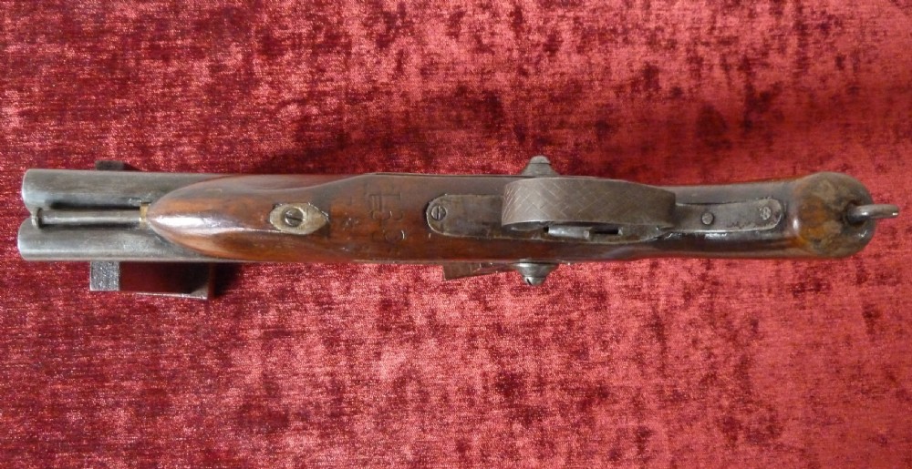 A 19th-century double-barrel percussion pistol featuring side-by-side steel barrels, dual hammers, engraved lockplates, and a smooth walnut stock. View IX