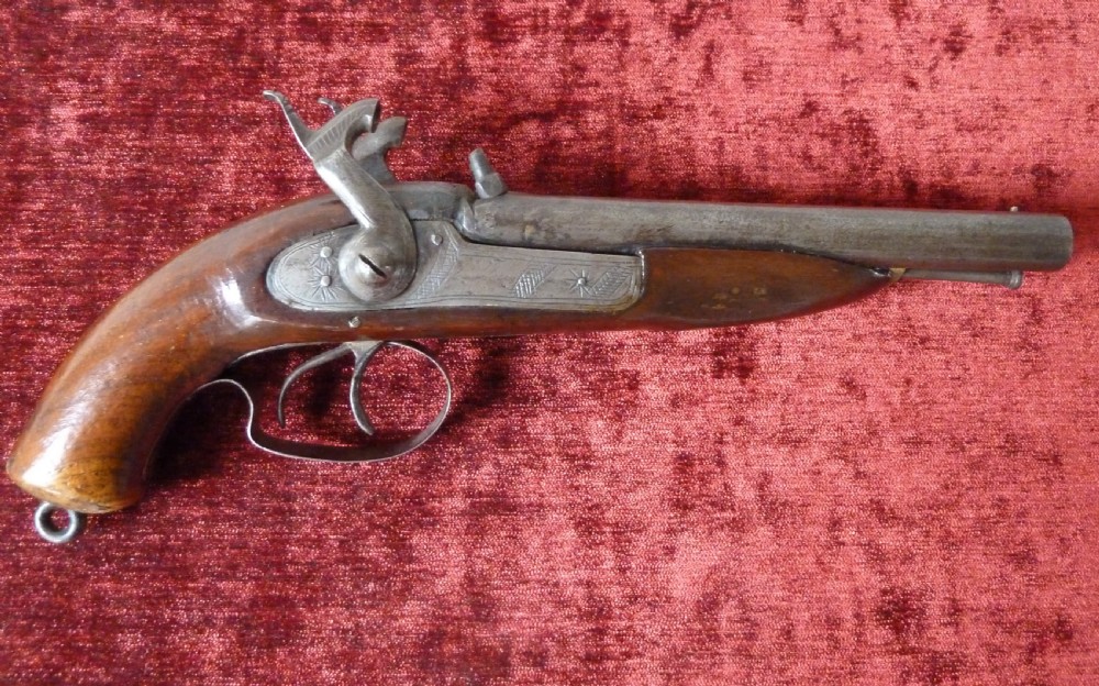 A 19th-century double-barrel percussion pistol featuring side-by-side steel barrels, dual hammers, engraved lockplates, and a smooth walnut stock. View X