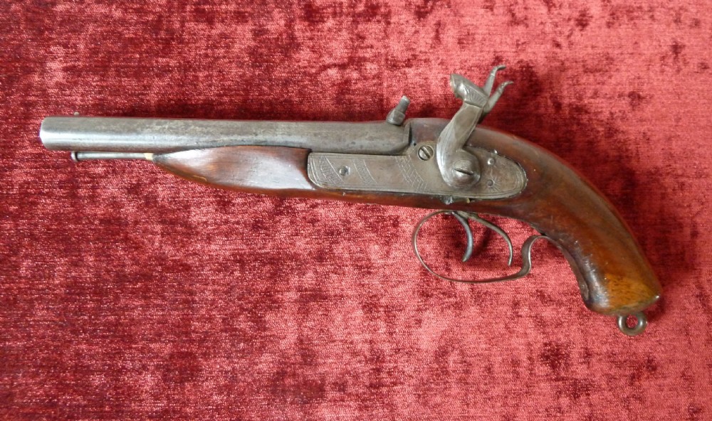 A 19th-century double-barrel percussion pistol featuring side-by-side steel barrels, dual hammers, engraved lockplates, and a smooth walnut stock. View XI