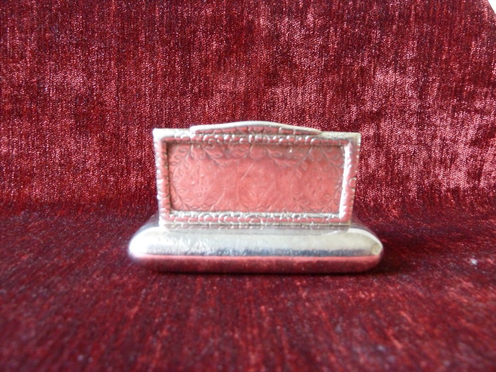 An open rectangular Georgian sterling silver snuff box displaying hallmark stamps on its gilded interior. View VI