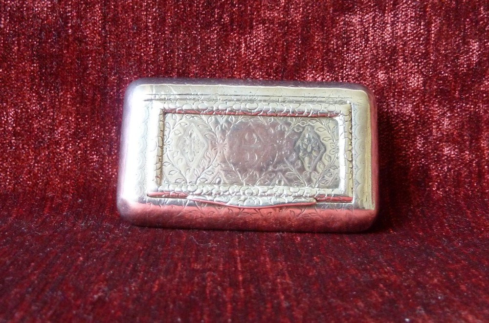 An open rectangular Georgian sterling silver snuff box displaying hallmark stamps on its gilded interior. View VII