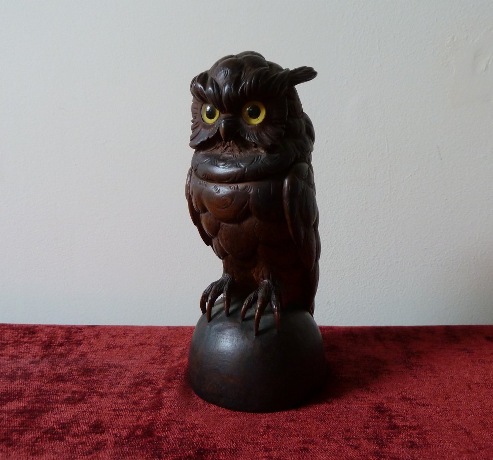 A detailed hand-carved dark wood owl inkwell featuring inset yellow glass eyes perched upon a rounded wooden dome base. View II