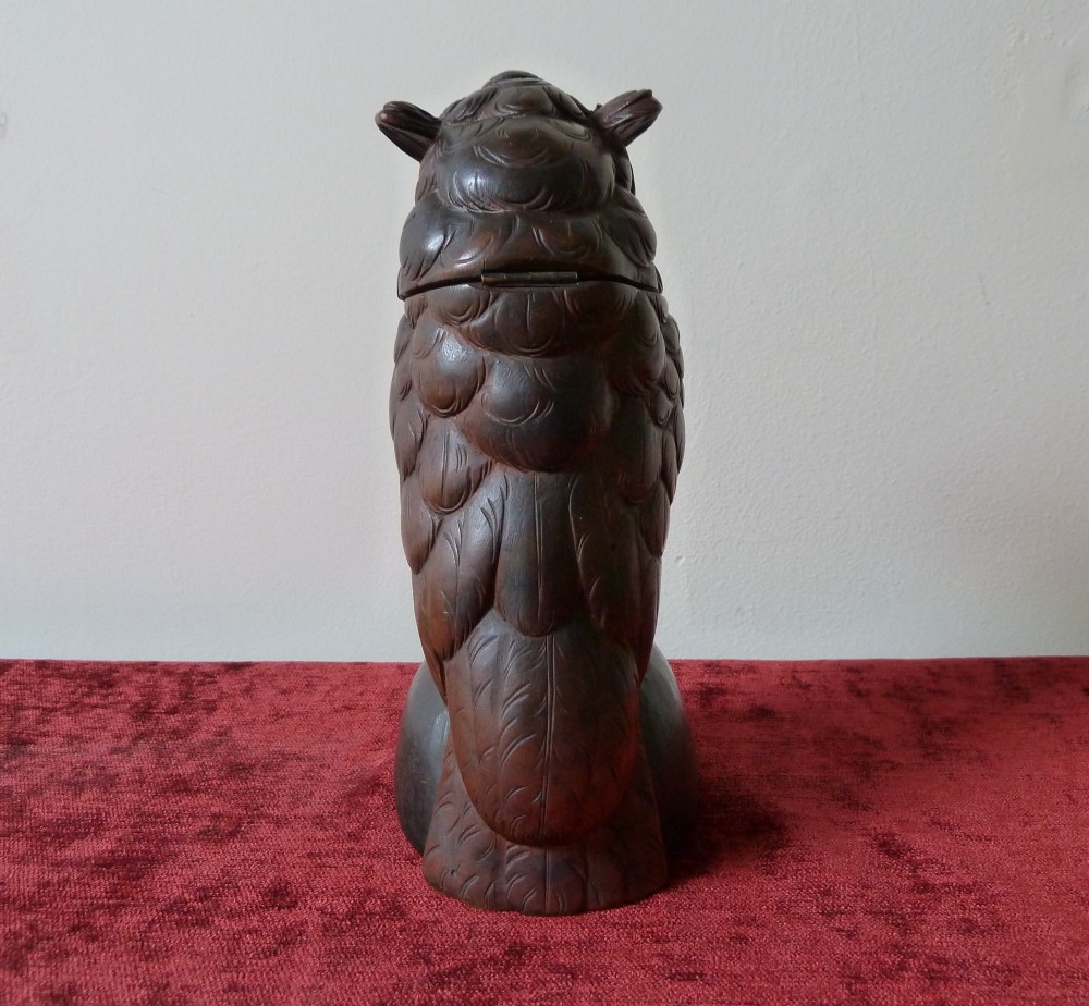A detailed hand-carved dark wood owl inkwell featuring inset yellow glass eyes perched upon a rounded wooden dome base. View IV