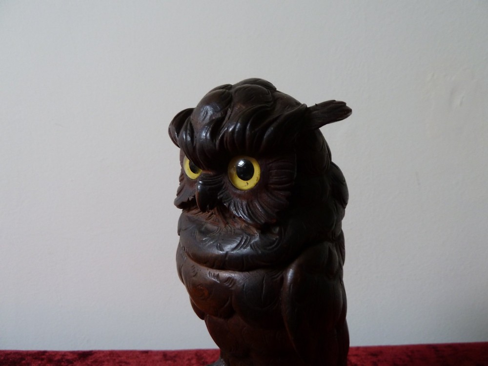 A detailed hand-carved dark wood owl inkwell featuring inset yellow glass eyes perched upon a rounded wooden dome base. View VI