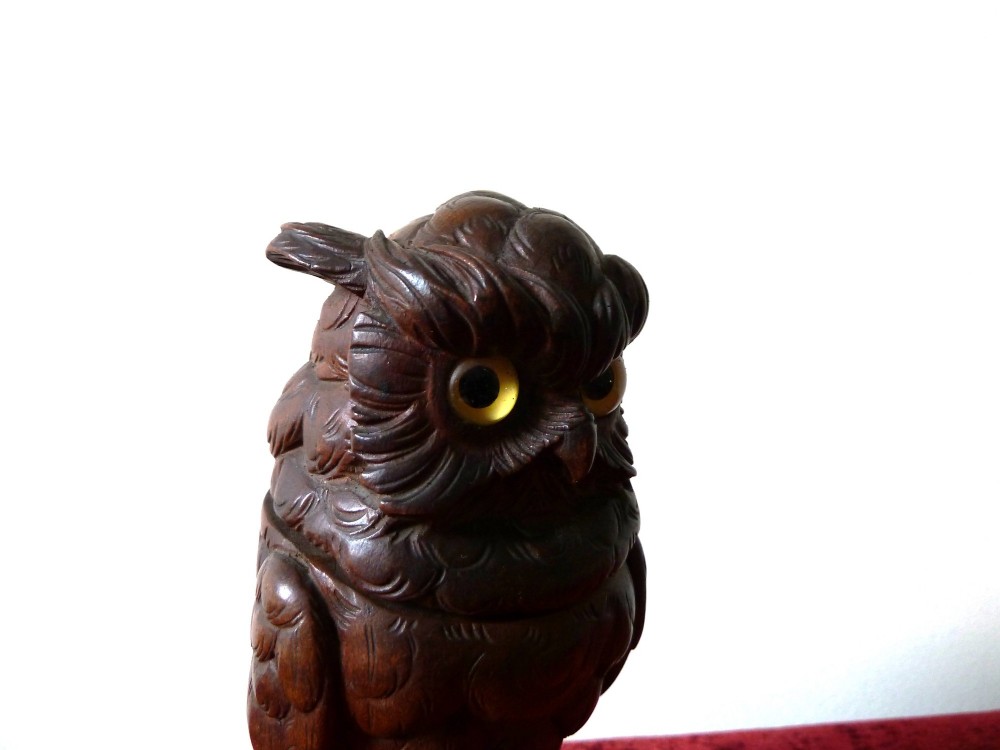 A detailed hand-carved dark wood owl inkwell featuring inset yellow glass eyes perched upon a rounded wooden dome base. View VII