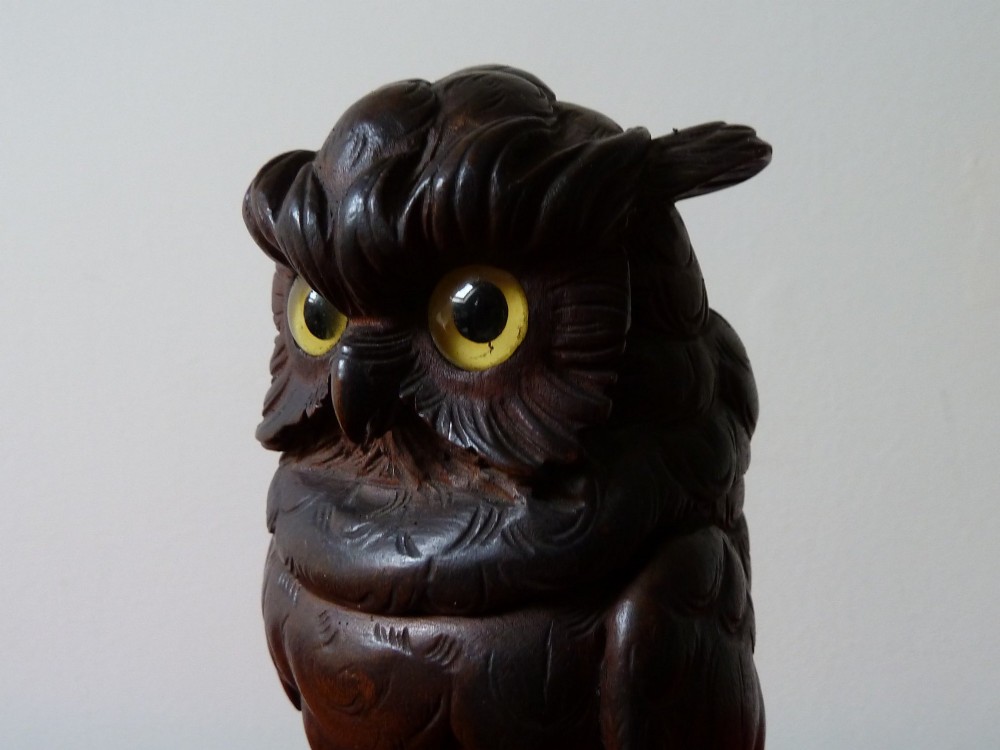 A detailed hand-carved dark wood owl inkwell featuring inset yellow glass eyes perched upon a rounded wooden dome base. View XI