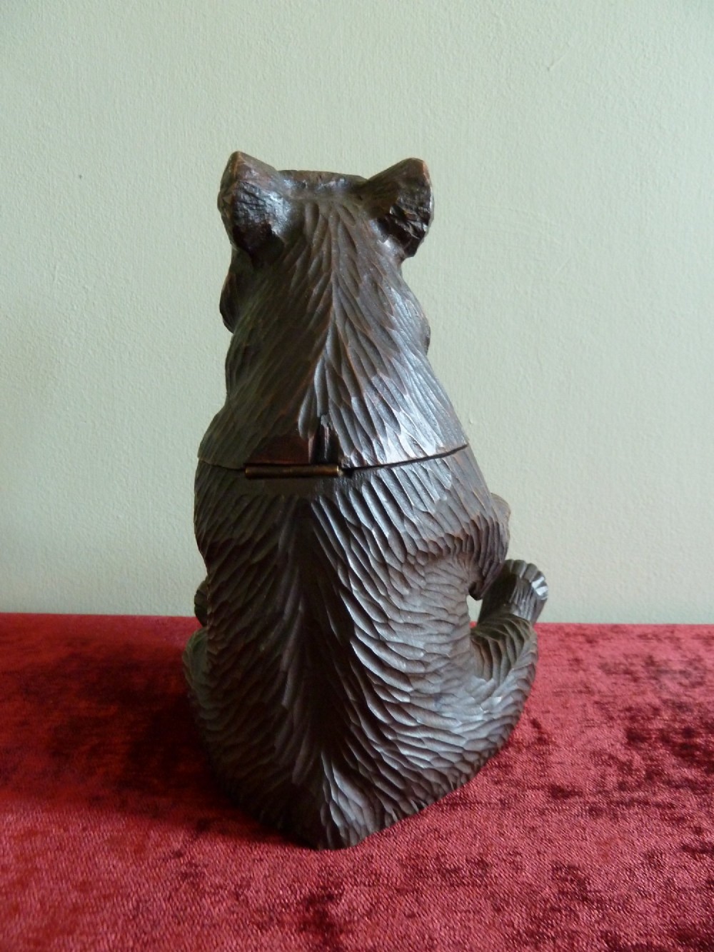 A carved dark brown wooden Black Forest bear depicted in a seated position with open jaws, featuring a removable head function. View V